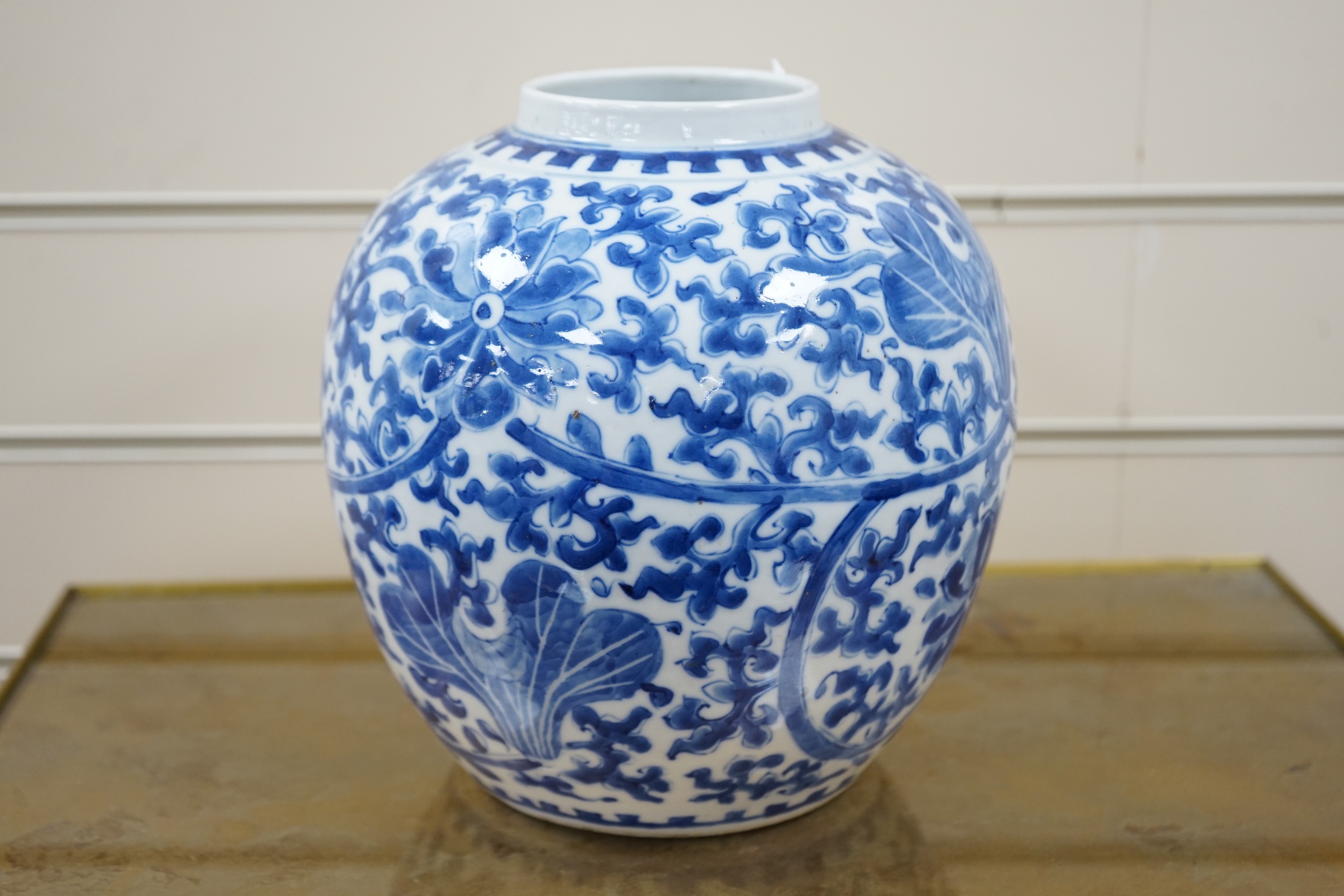 A late 19th century Chinese blue and white ovoid jar. 22cm tall, apocryphal Kangxi mark
